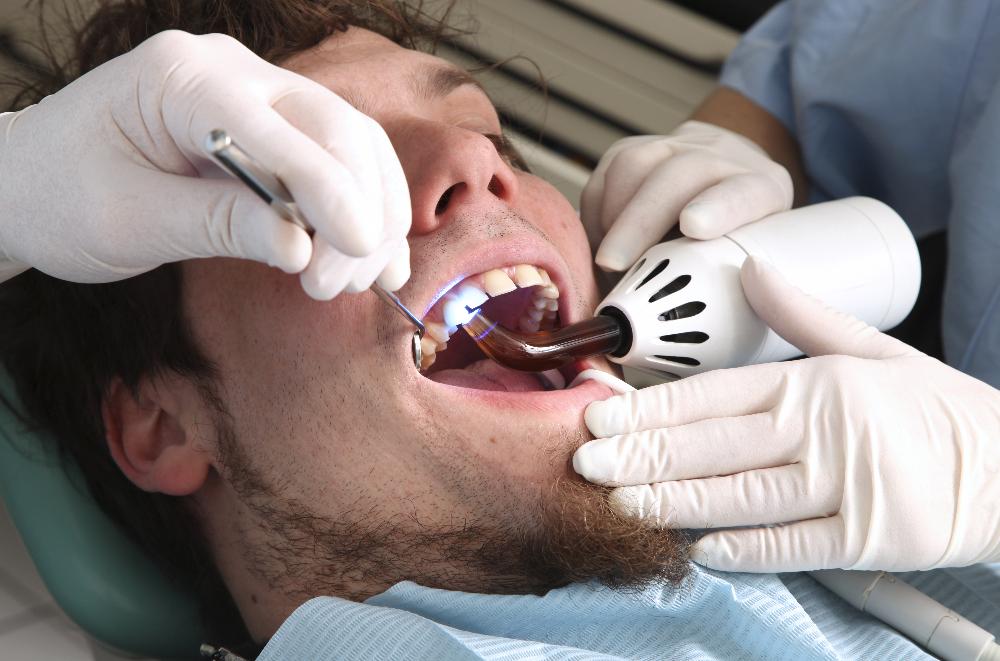 man receiving dentist exam | dental crowns allentown pa