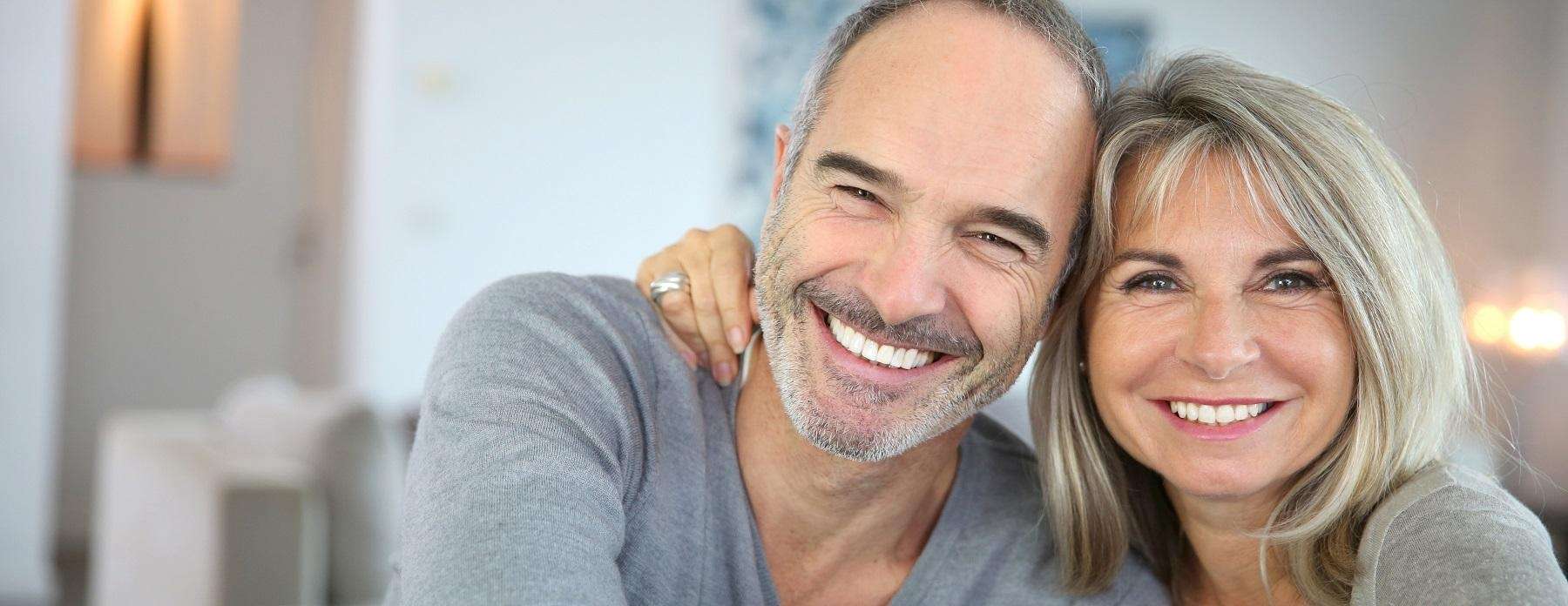A smiling older couple with dentures