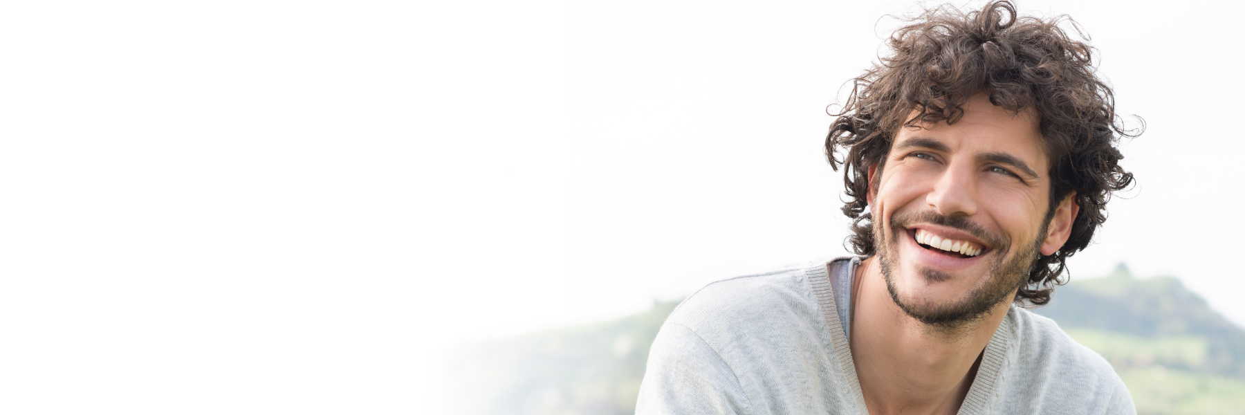 Confident man smiling outdoors, representing peace of mind after seeking a dental second opinion