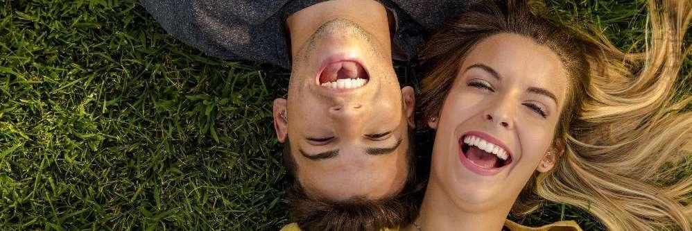 couple smiling on grass | allentown dentist