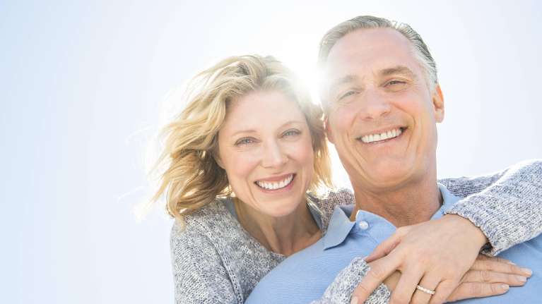 A smiling older couple outside | dentures Allentown PA