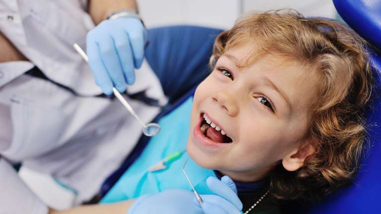 child smiling during dentist appointment