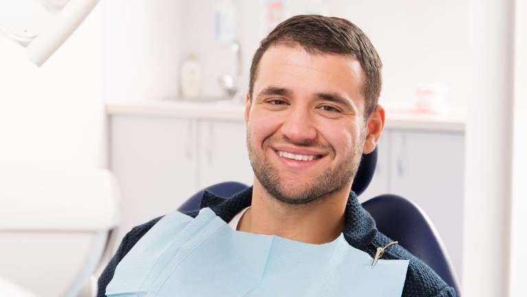 A smiling man getting a dental exam | Allentown PA 18103