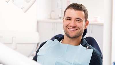 A smiling man in the dentist's chair | tooth extraction Allentown