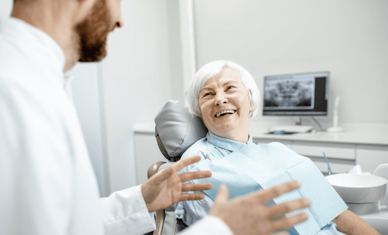 A dentist speaking with his patient | dentist Allentown
